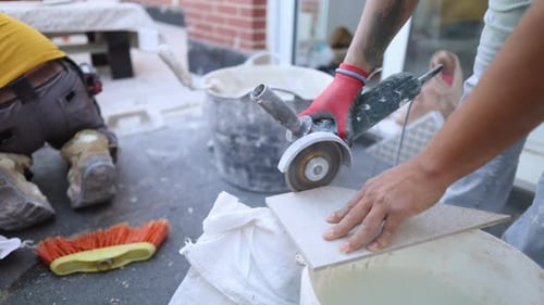 Construction Workers Cutting Tile with Power Saw