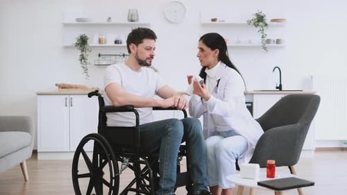 Woman Doctor Measure Body Temperature of Male with a Disability Patient at Home
