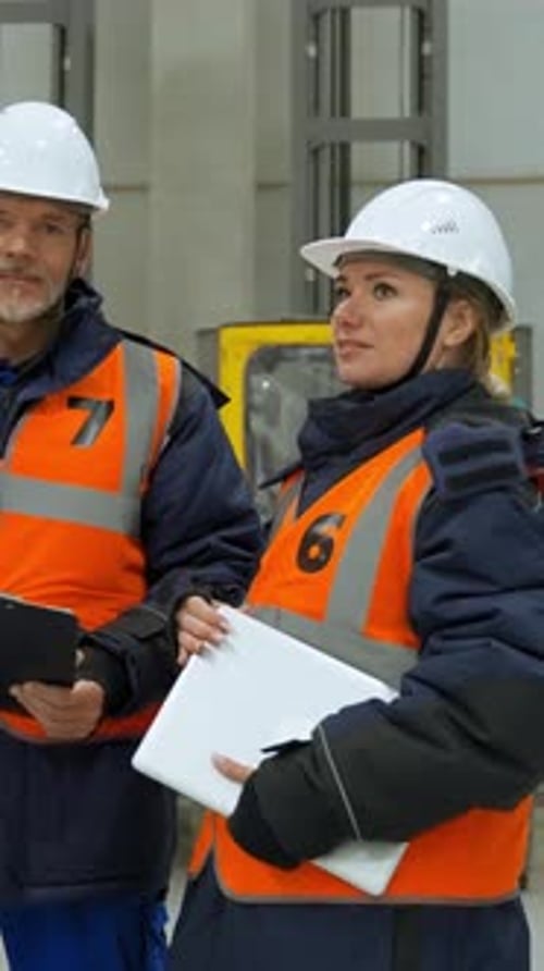 Vertical of Engineers in Professional Uniform Stand in Storage Terminal