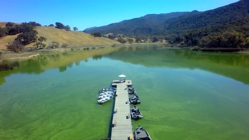 View of Gorgeous Mountainside Lake on Sunny Day by Aerial Drone Above
