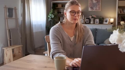 Woman Working on Laptop at Home