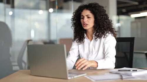 Businesswoman in Office Suffering From Back Pain While Working on Laptop