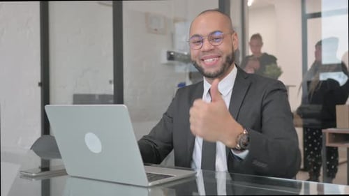 Thumbs Up from Confident Business Man in Office