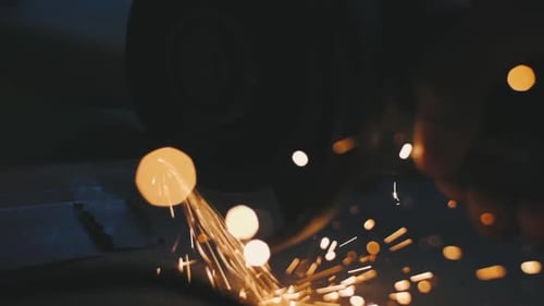 Man Works Circular Saw Sparks Fly From Hot Metal Man Hard Worked Over the Steel Closeup Slow Motion