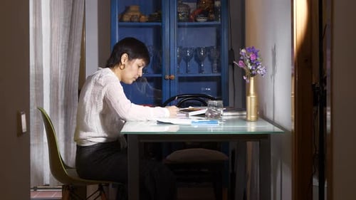 Creative female fashion designer creating artistic illustration drawing in home workshop