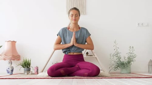 Woman in Lotus Pose Meditating at Home