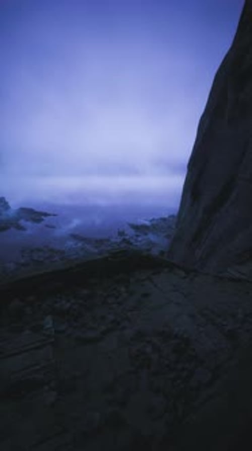 Mysterious Twilight By the Rocky Shore Under a Cloudy Sky