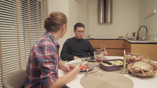 Couple Eating Dinner at Kitchen Table