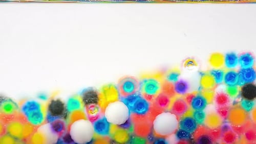 Colorful Gel Beads in Water Macro Abstract