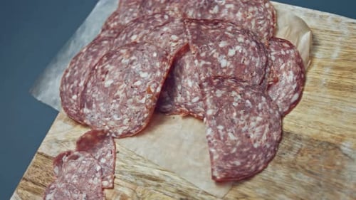 Smoke Transformation Effect of Heart Shapes of Fresh Italian Sliced Salami Sausage on a Wooden Tray