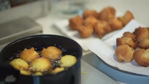 A woman making sata andagi