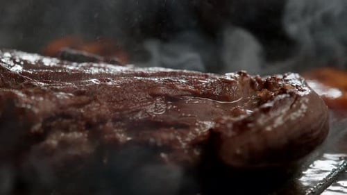 Juicy Steak Cooking on a Sizzling Grill Pan
