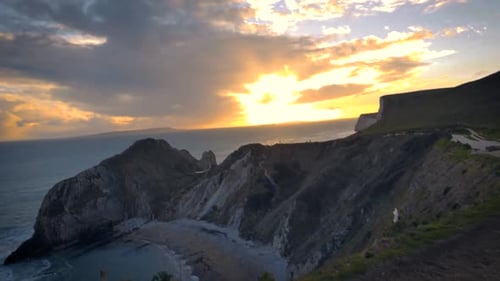 A bewitching sunset view from the cliffs of Durdle door, Dorset, England showing beautiful sky,mount