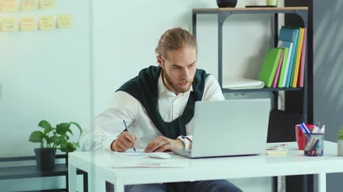 Serious Young Man Use Laptop Video Call Speaking in Office Business Writing Technology Handsome Work