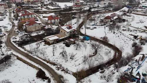 Snow Covered Rural Village – Aerial Drone View of Countryside Homes in Winter