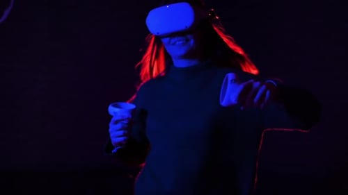 Woman Using Virtual Reality Headset in Dark Room