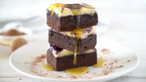 Stacked Brownies Drizzled with Honey on a Plate