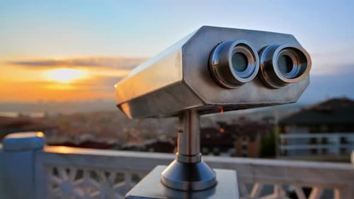 Binoculars on a viewpoint located in Balat district in Istanbul, Turkey. Sunset and downtown on the