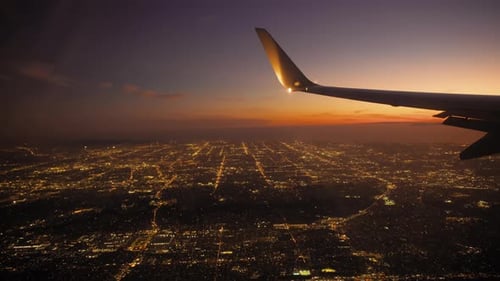 Airplane Jet Plane Prepare to Landing in Los Angeles LAX Airport Porthole View with Wing on Sunset