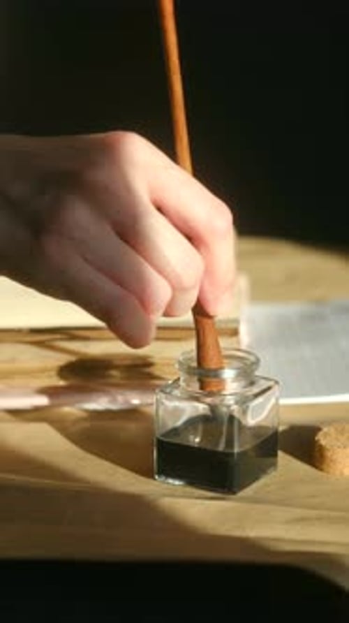 Calligrapher Dipping Vintage Pen Into Black Inkwell for Writing