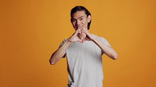 Happy Man Makes Heart Shape With Hands