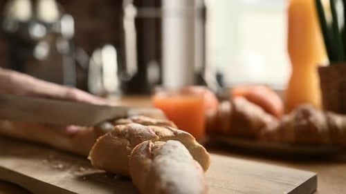 Cutting a French Baguette on a Cutting Board