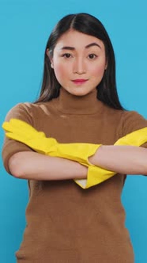 Young Adult Puts On Cleaning Gloves