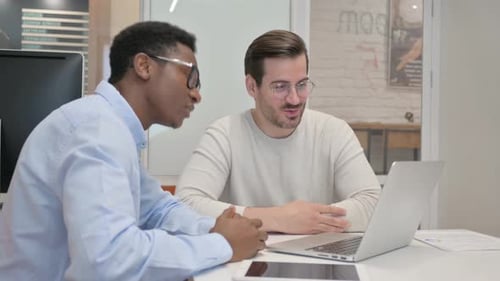 Two Men Discussing Business on Laptop Computer