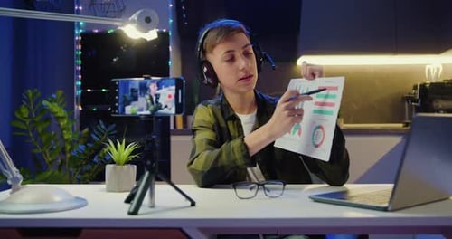 Boy Using Smarthone is Live Streaming a Training Blog at Home. Chat Online with Channel Subscribers.