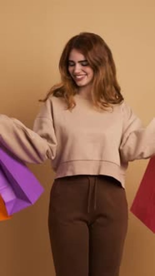 Cheerful Woman Holding Colorful Shopping Bags Indoors