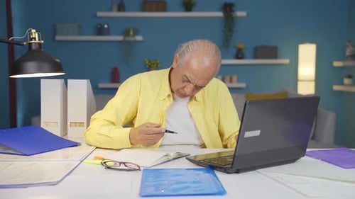Home office worker old man working seriously and focused.