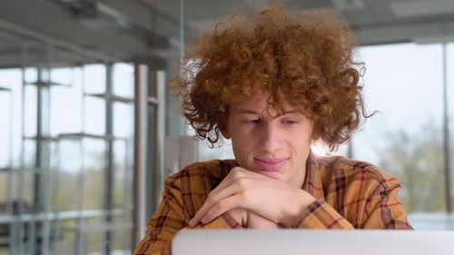Young Adult with Laptop in Modern Office Setting
