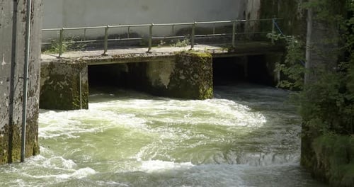 Water flows out of a hydropower plant, weir