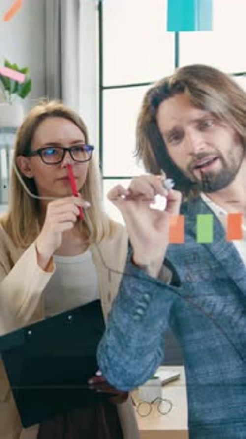 View Through Glass Board on Attractive Active Positive Skillful Man and Woman Which Creating New