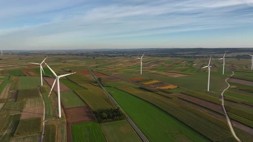 Wind turbines generating power in green energy fields of sustainable agriculture