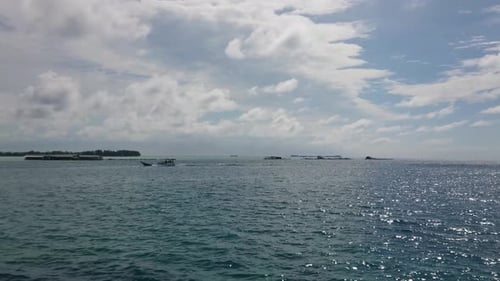 Boat sailing with sun reflection on the sea water