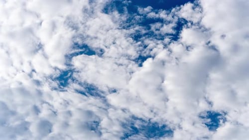Time Lapse of White Clouds Moving Across Bright Blue Sky