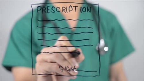 Doctor Writes Prescription on Clear Surface