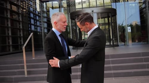 Businessmen Handshake Outside Modern Office Building