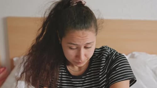 Sad Woman Lying in Bed Crying in Bedroom