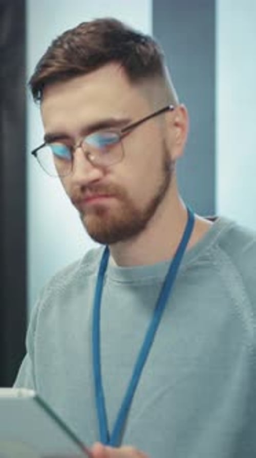 Focused Professional Utilizing a Tablet in a Contemporary Modern Office Environment