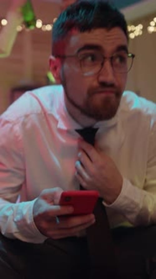 Young Adult Using Phone at Party