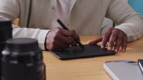 Person Using Graphics Tablet at Desk