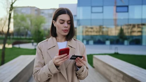 Woman Purchases Online with Credit Card and Phone