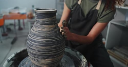 Woman Shaping Clay Vase on Pottery Wheel