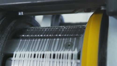 Close View of Strands Moving Through Industrial Machine