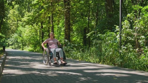 Woman in Wheelchair Enjoying a Peaceful Nature Walk