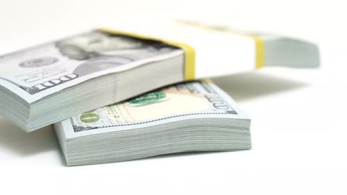 Stack of Bank Bundles with US Dollars on a White Background Closeup Shot of New Freshly Printed