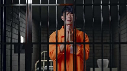 Prisoner In Handcuffs In Prison, Making Pray Hand Gesture Asking For Something