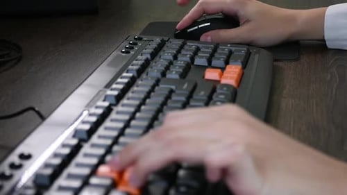Hands Typing on Computer Keyboard at Workplace